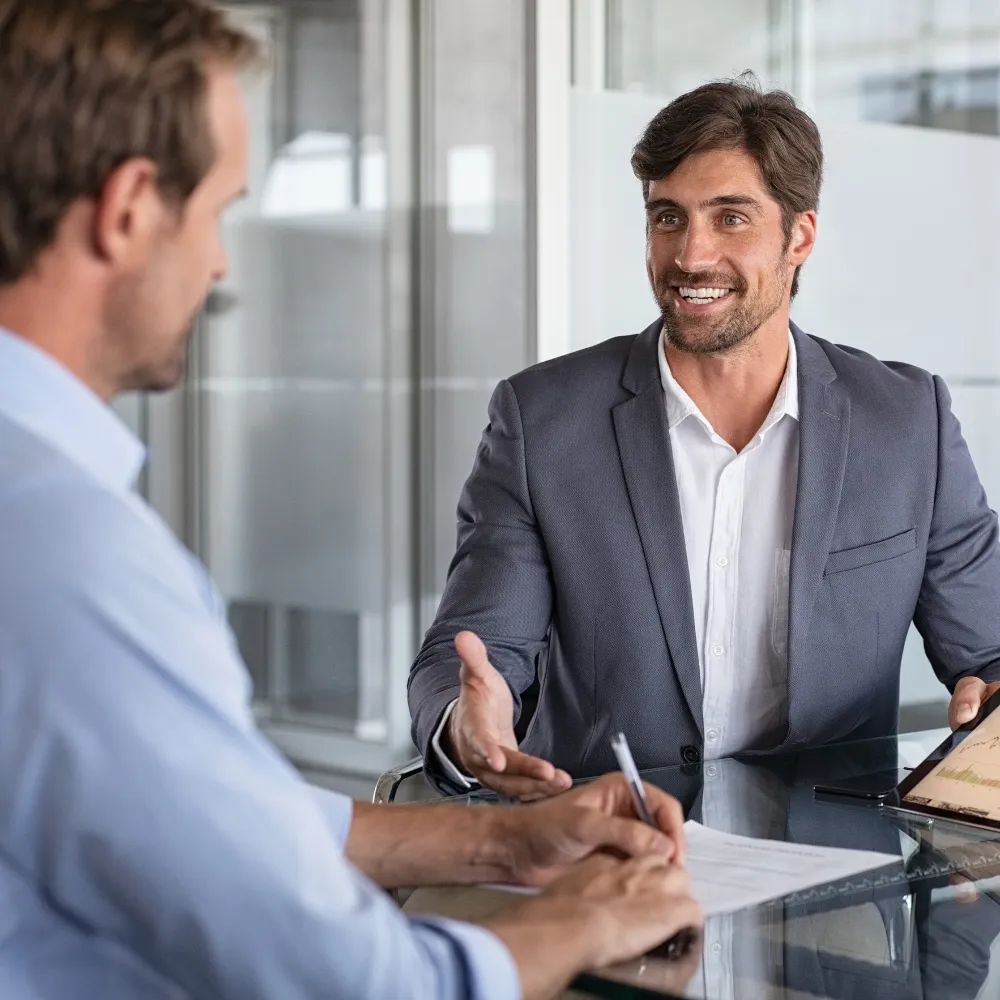 A Blissful consultant meeting with a practice owner across a desk